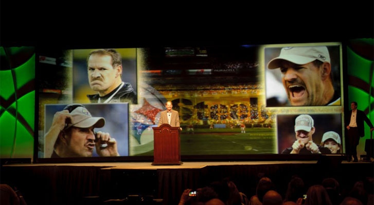 Image: Former NFL coach speaks at a corporate event. Sports event marketing, strategy and development by Benchmarc360.